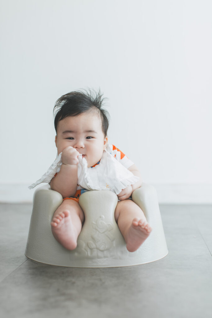 お宮参りスタジオ撮影で涎掛けだけをつけたおしゃれな赤ちゃん写真